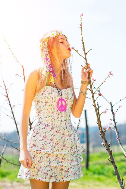 Girl kisses the blossoming of a flower in spring