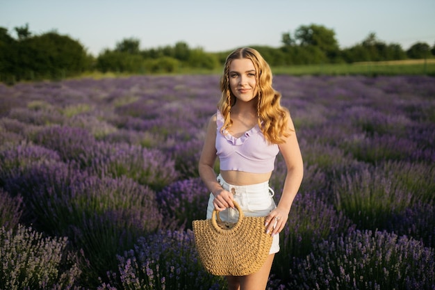 Girl in a lavender field Woman in a field of lavender flowers at sunset in a white dress France Provence