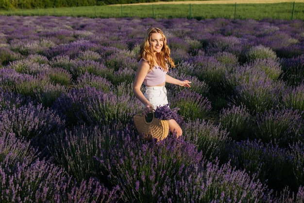 Girl in a lavender field Woman in a field of lavender flowers at sunset in a white dress France Provence