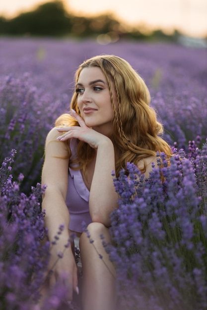 Girl in a lavender field Woman in a field of lavender flowers at sunset in a white dress France Provence