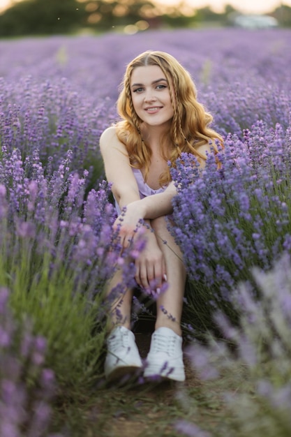 Girl in a lavender field Woman in a field of lavender flowers at sunset in a white dress France Provence