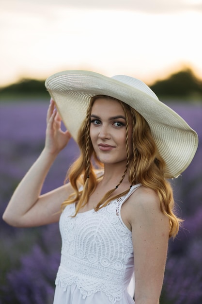 Girl in a lavender field Woman in a field of lavender flowers at sunset in a white dress France Provence