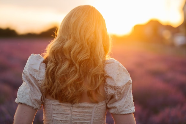 Girl in a lavender field Woman in a field of lavender flowers at sunset in a white dress France Provence