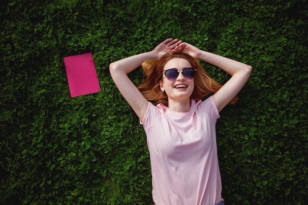 Girl lies on the grass. photo above.