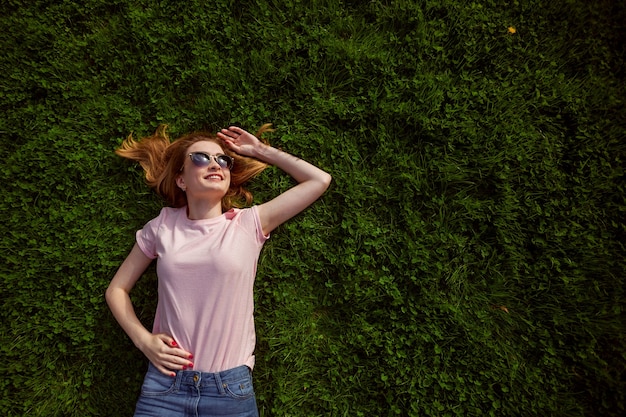 Girl lies on the grass. photo above.