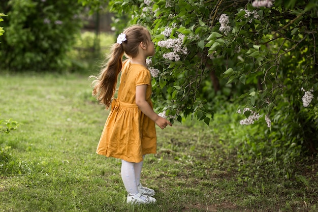 girl and lilac flowers in the garden in summer