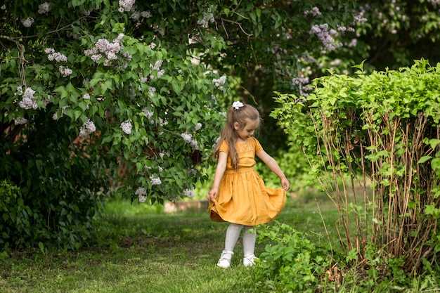 girl and lilac flowers in the garden in summer