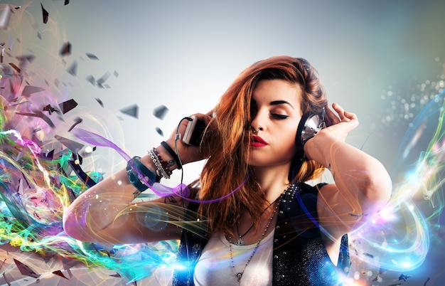 Girl listening to music with headphones on bright colored streaks