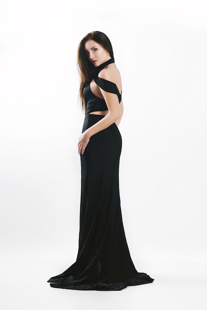 Girl in a long evening dress on a white background