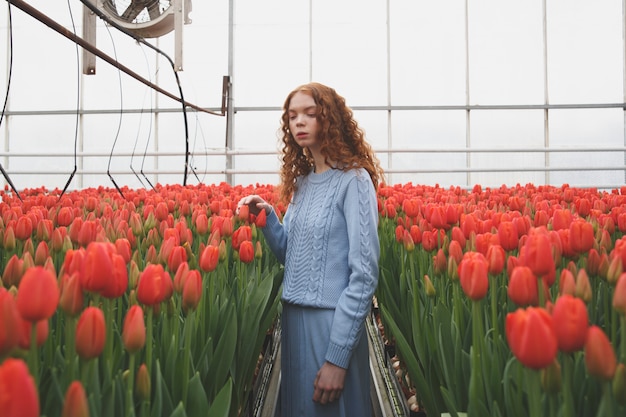 Girl looking down in orangery