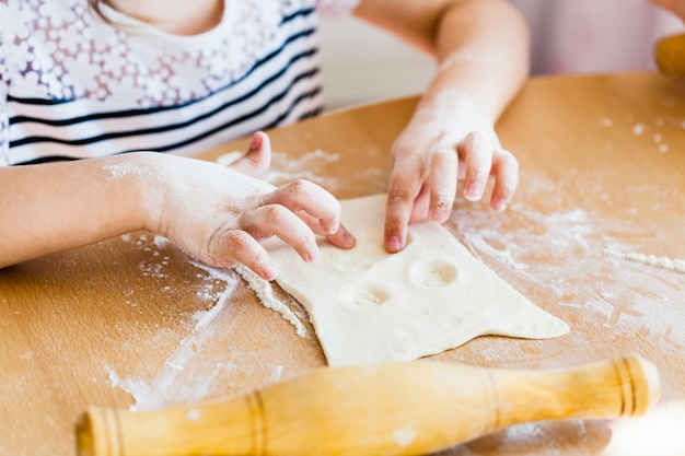 girl makes pastry  dough, rolling pin, flour, baking, cooking from dough and flour