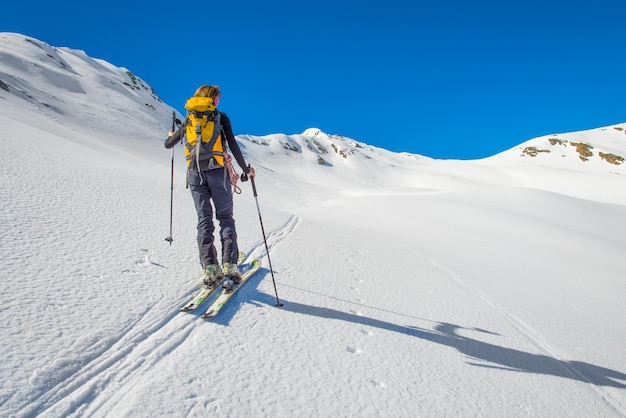 Girl makes ski mountaineering Randonnee ski trails