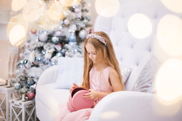 Girl makes a wish, dreams with the Christmas tree