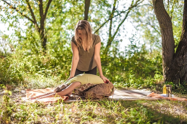 Girl on massage in nature with massage therapist.