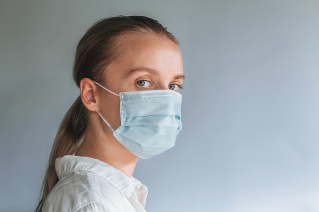 A girl in a medical mask. copy space