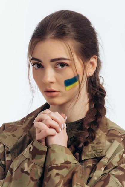 Girl in military uniform Ukrainian flag of Ukraine on the face War in Ukraine Bucha on a white background