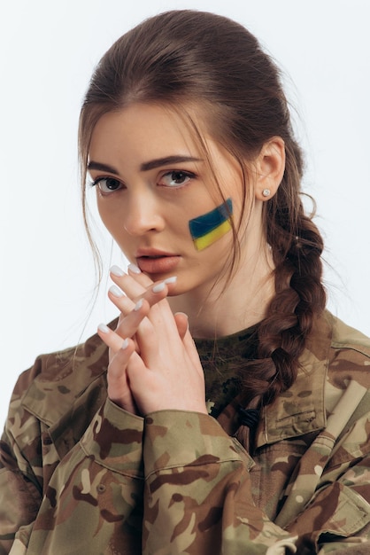 Girl in military uniform Ukrainian flag of Ukraine on the face War in Ukraine Bucha on a white background