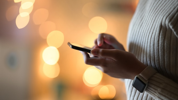 Girl and mobile phone over bokeh night