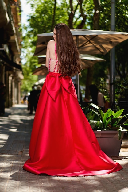 Girl model in a white dress on the street