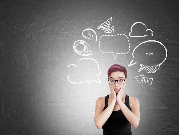 Girl near blackboard with speech bubbles