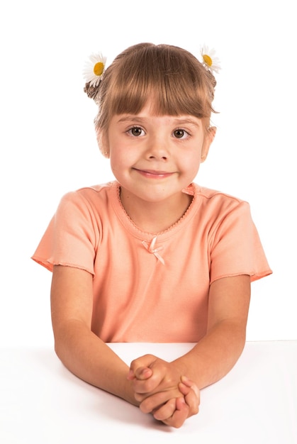 Girl in an orange Tshirt and flowers in her hair on a white background