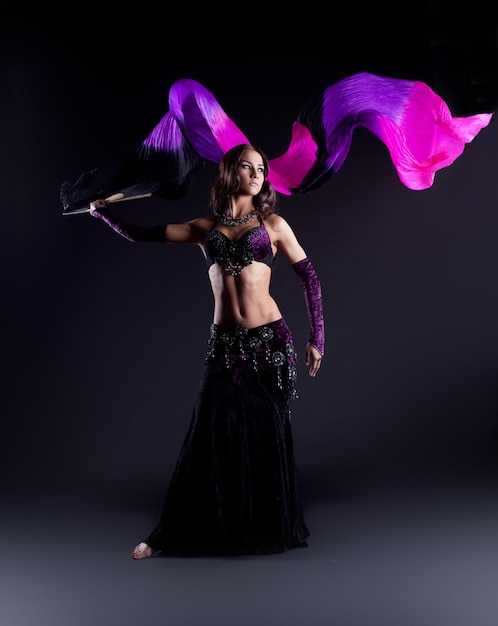 Girl in oriental arabic costume dance with fantail