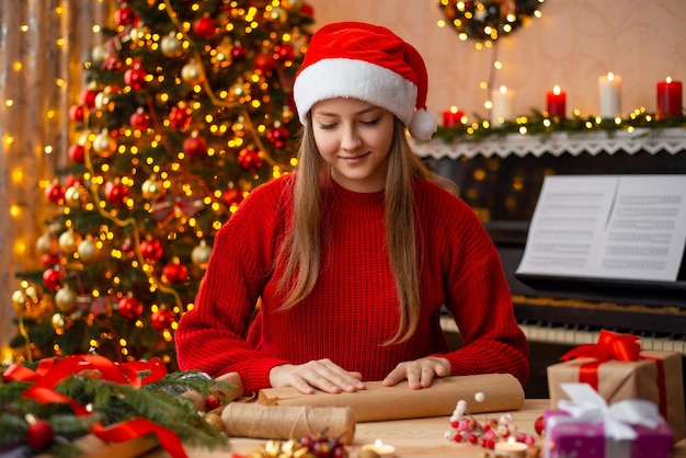 Girl packing Christmas gift boxes and making decor for the house Merry Christmas and happy new year concept