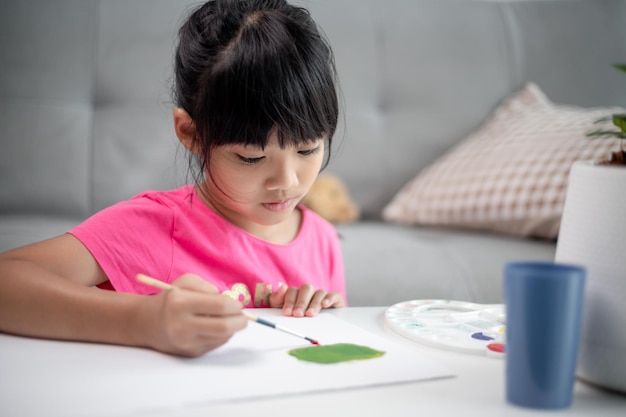 Girl Painting Picture On Table At Home