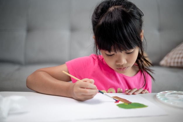 Girl Painting Picture On Table At Home