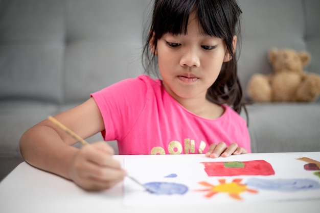 Girl Painting Picture On Table At Home