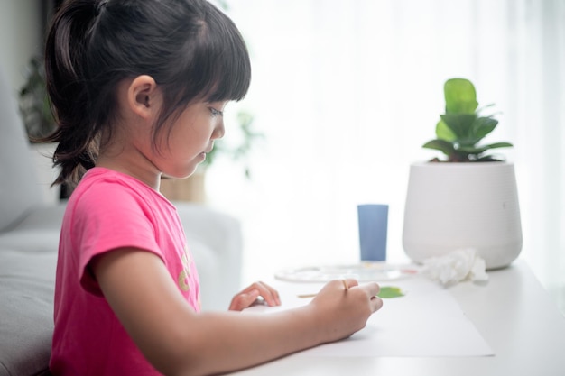 Girl Painting Picture On Table At Home