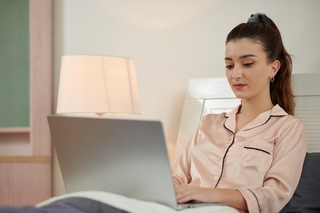 Girl in Pajamas Working on Laptop