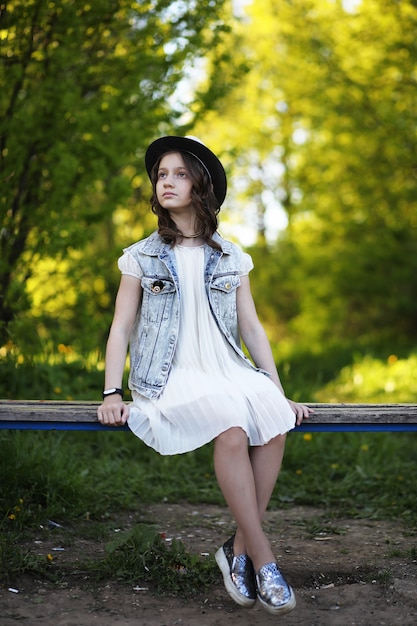 Girl in the park in the evening of a sunny day in the spring