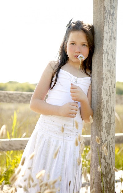 Girl at the park playing with flower spike