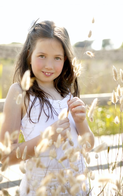 Girl at the park playing with flower spike