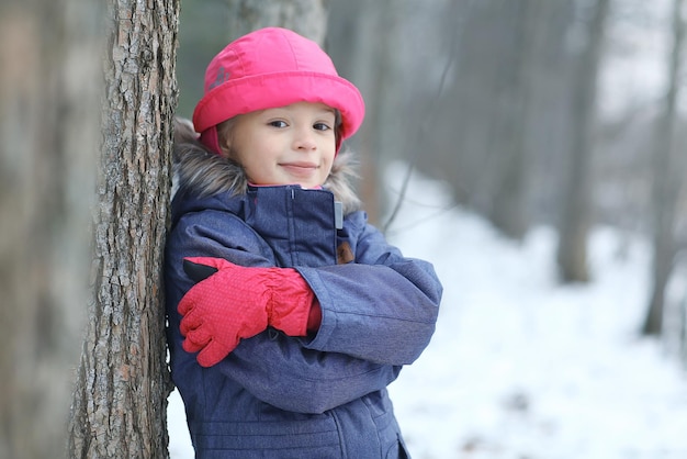 Girl in the park winter snow walk