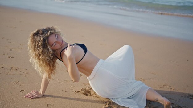 Girl performing dance sand sunny beach close up sensual woman moving smoothly