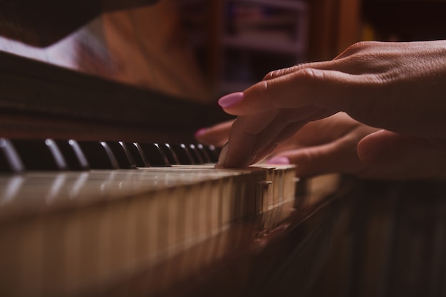 Girl and piano at home selective focus