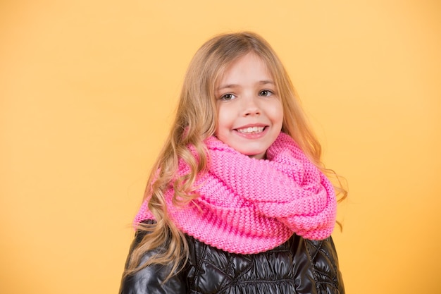 Girl in pink scarf on orange background