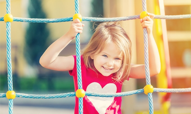 Girl playing on playground in city park