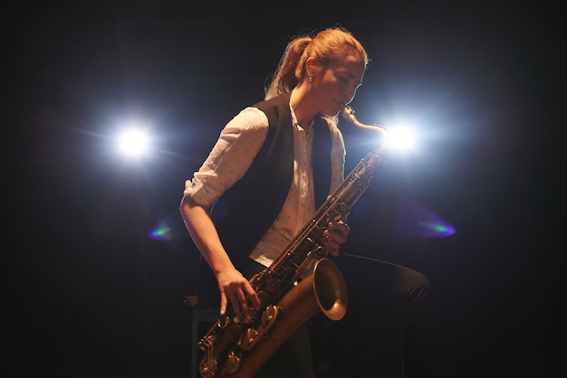 The girl playing the saxophone