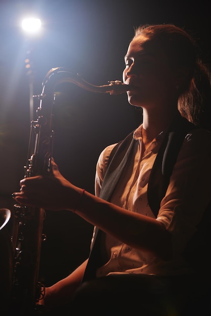 The girl playing the saxophone