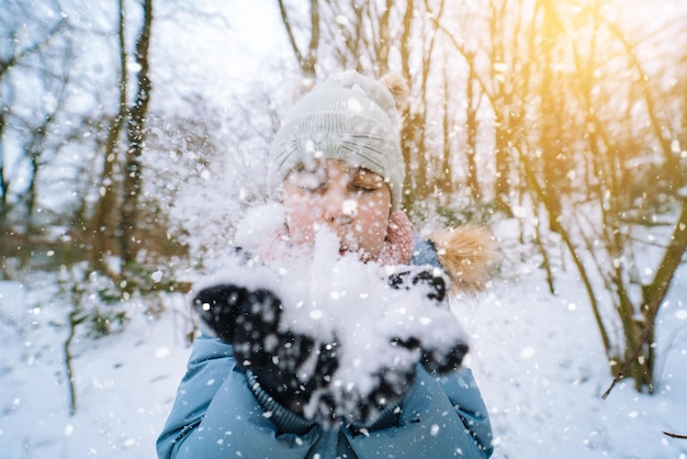 Girl playing on snow in winter time happy children in beautiful snowy winter forest on christmas day