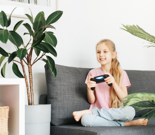 Girl playing video game at home