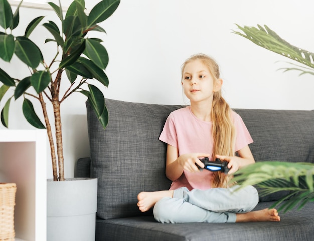 Girl playing video game at home