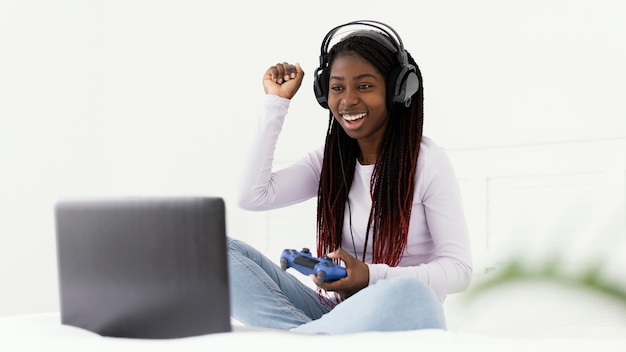 Girl playing videogame full shot