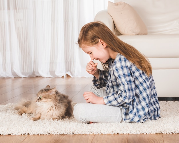 Girl playing with cat