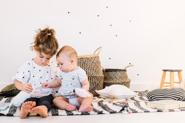 Girl playing with cute baby