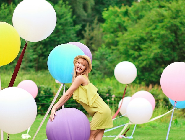 Girl playing with multicolor balloons 