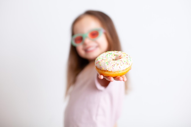 The girl points her finger at the doughnut with a disgruntled face Emotions Harmful food